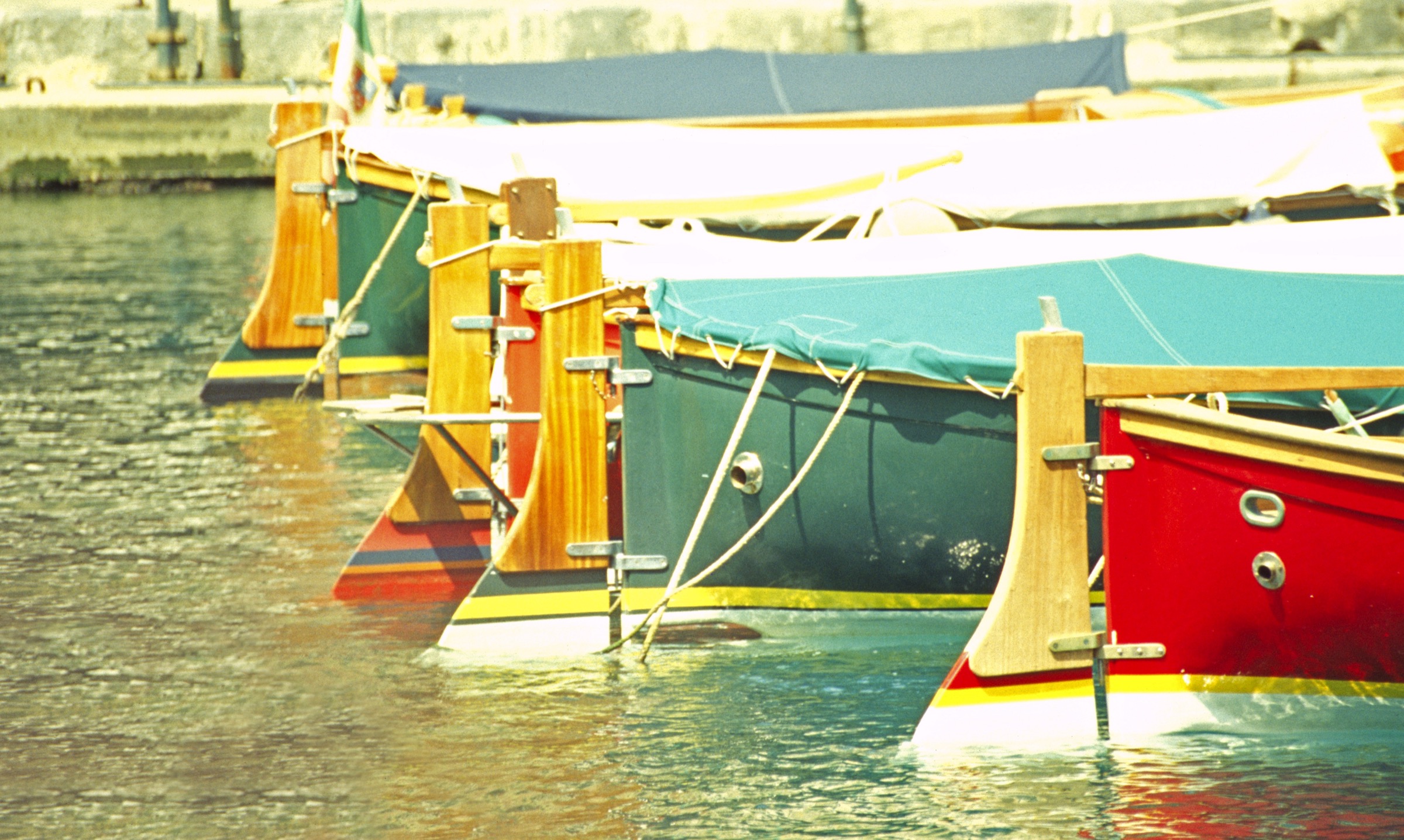 Pastel harbor facades and wooden boats in Portofino, Italy