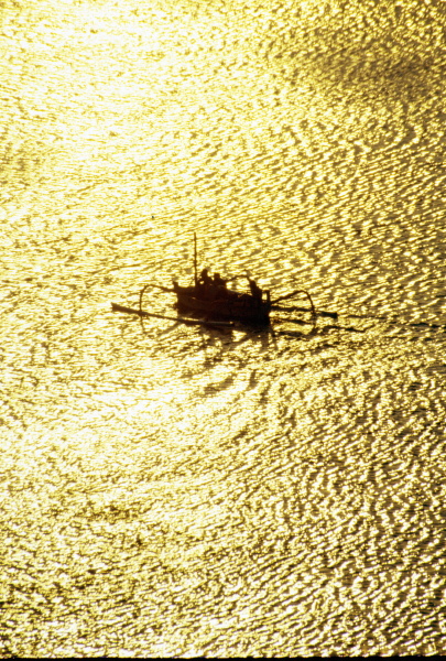 Fisherman silhouetted against tropical water in Indonesia