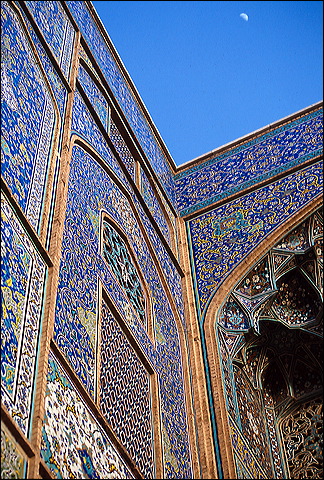 Crescent moon rising beside an ancient dome in Iran