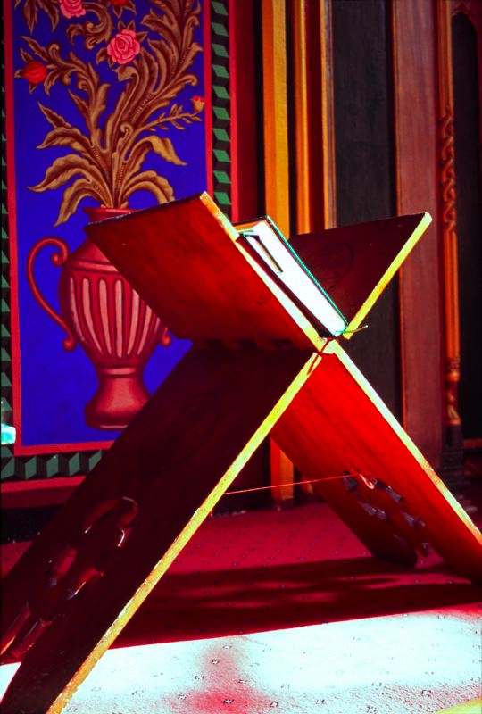 Carved wooden book stand inside a historic building in Lefkoşa