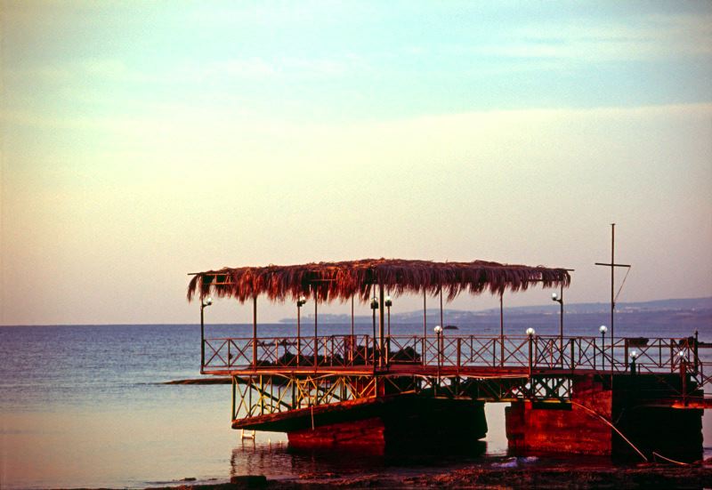 Wooden pier extending into turquoise sea in Northern Cyprus
