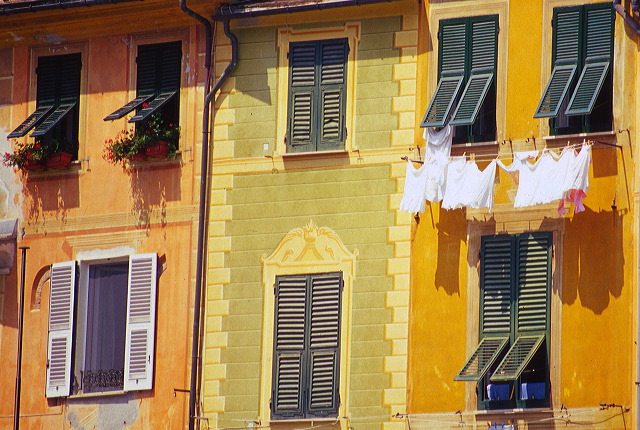 Green shutters and textured stone wall in Portofino